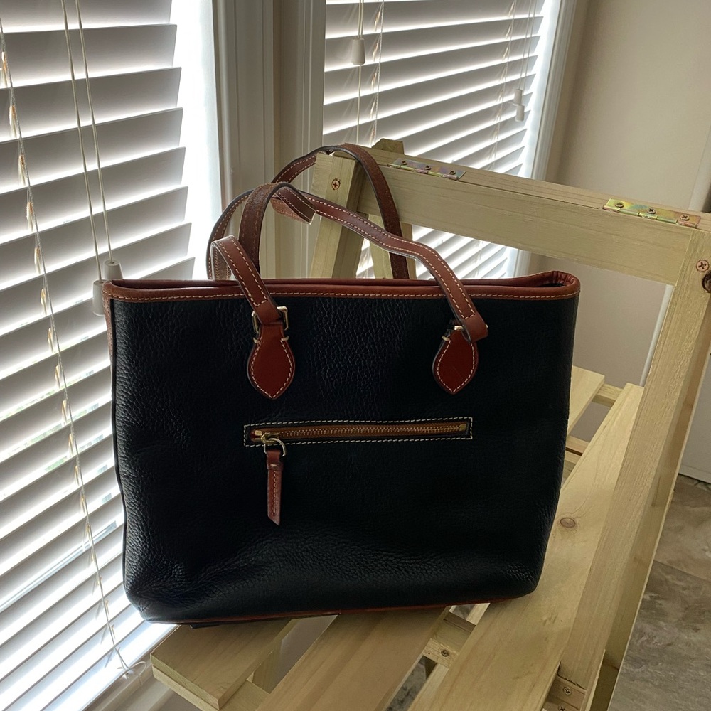 Dooney & Bourke medium tote. Black with brown trim.